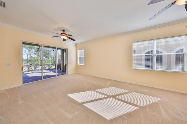 carpeted empty room with ceiling fan and ornamental molding