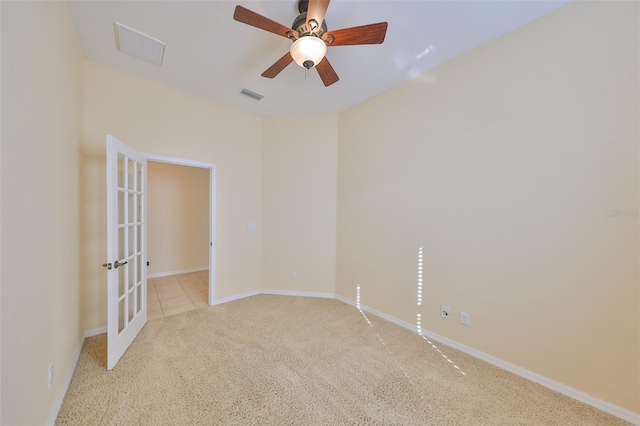 carpeted spare room featuring ceiling fan