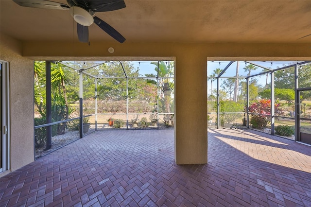 unfurnished sunroom featuring ceiling fan