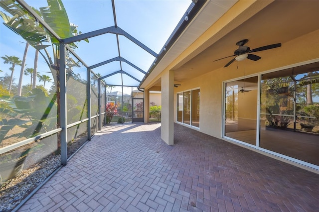 unfurnished sunroom with ceiling fan