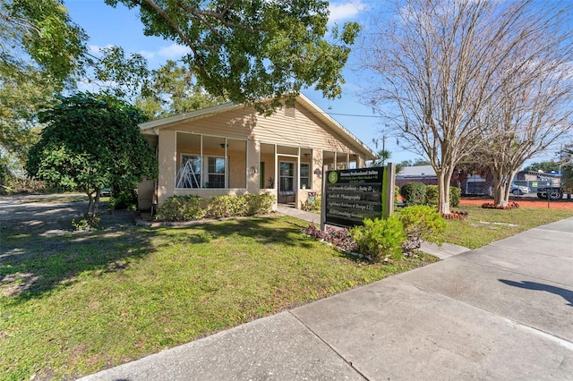 view of front of property with a front yard and covered porch