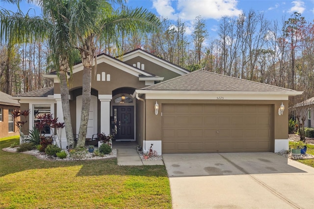 view of front of property with a garage and a front yard