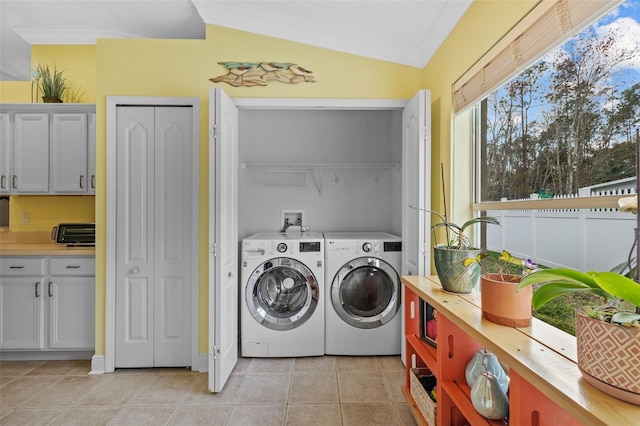 washroom with light tile patterned flooring and independent washer and dryer