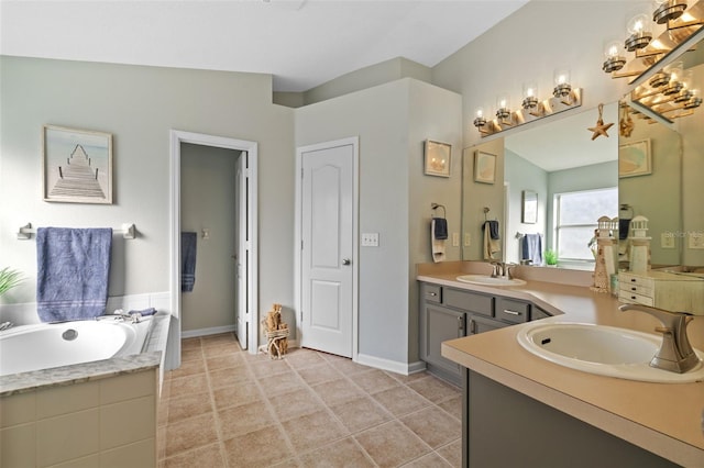 bathroom with vanity, tiled bath, and tile patterned flooring