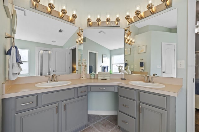 bathroom with tile patterned flooring, vanity, and lofted ceiling