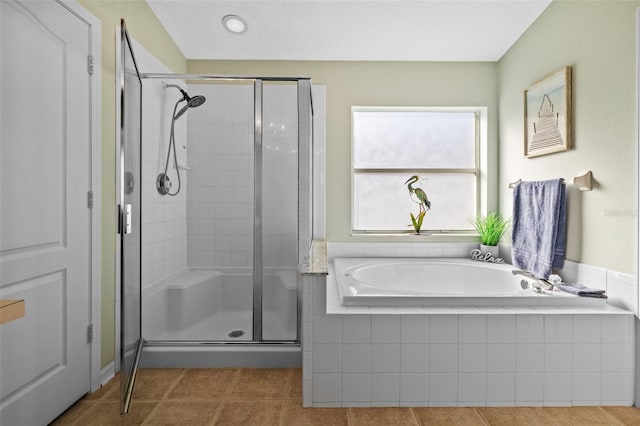 bathroom featuring tile patterned flooring and plus walk in shower