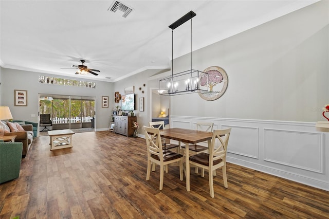 dining area featuring ornamental molding, dark hardwood / wood-style floors, and ceiling fan with notable chandelier