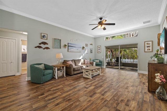 living room with crown molding, dark hardwood / wood-style floors, and ceiling fan