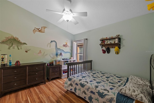 bedroom featuring ceiling fan, vaulted ceiling, and light wood-type flooring