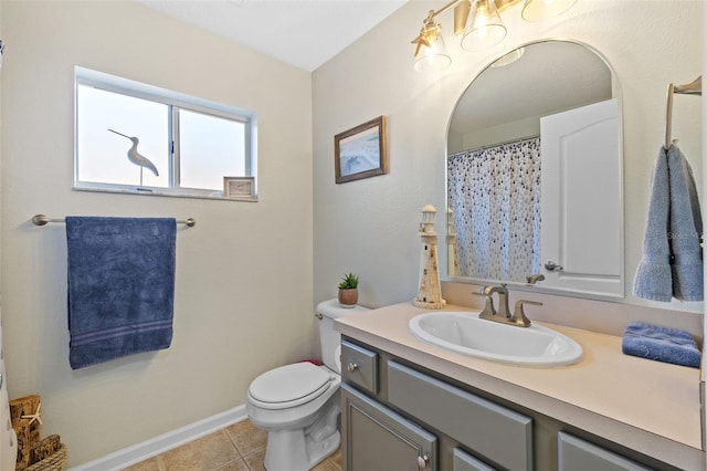 bathroom featuring vanity, tile patterned flooring, and toilet