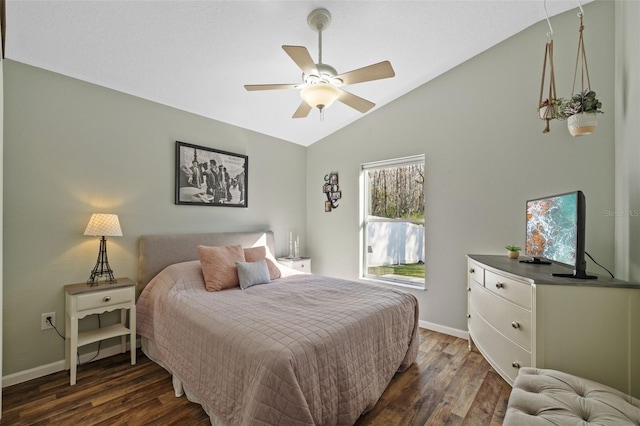 bedroom featuring dark hardwood / wood-style flooring, vaulted ceiling, and ceiling fan