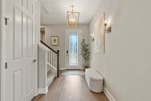 foyer featuring an inviting chandelier and hardwood / wood-style floors