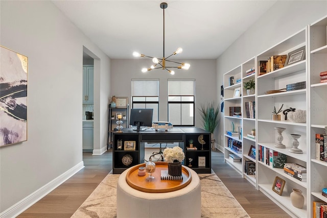 home office with hardwood / wood-style flooring and a chandelier