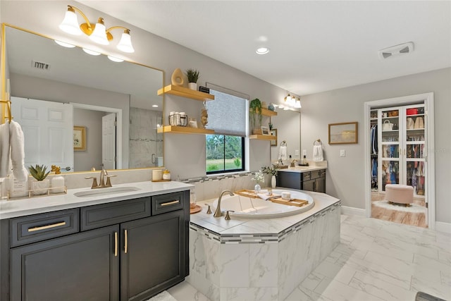 bathroom featuring vanity and shower with separate bathtub