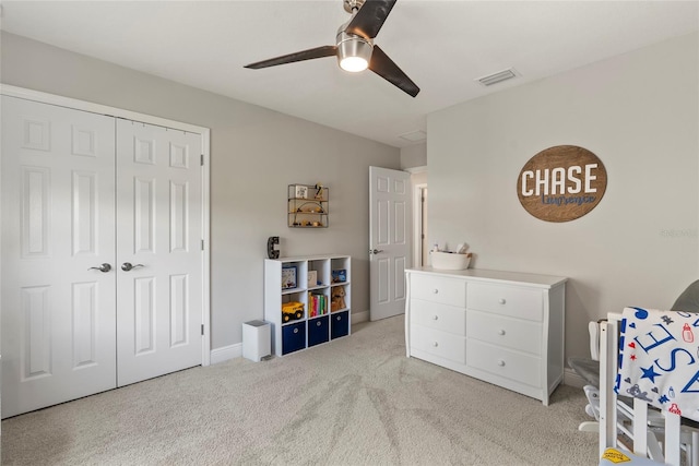 carpeted bedroom with a closet and ceiling fan