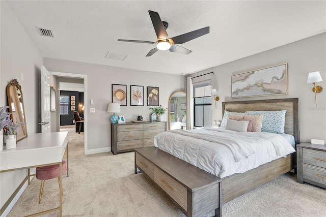 bedroom featuring light carpet and ceiling fan