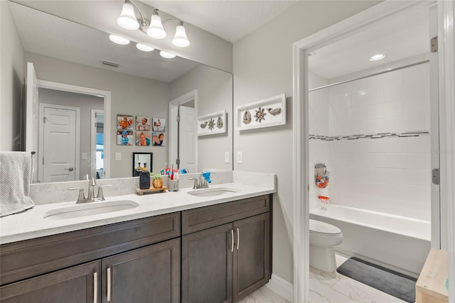 full bathroom featuring tiled shower / bath combo, vanity, and toilet