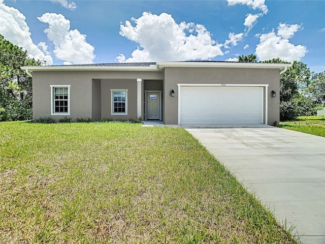 view of front of property featuring a garage and a front yard