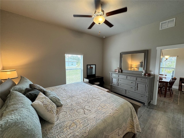 bedroom featuring multiple windows, hardwood / wood-style flooring, and ceiling fan