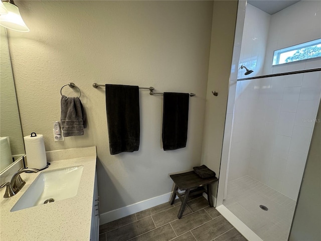 bathroom featuring vanity and tiled shower