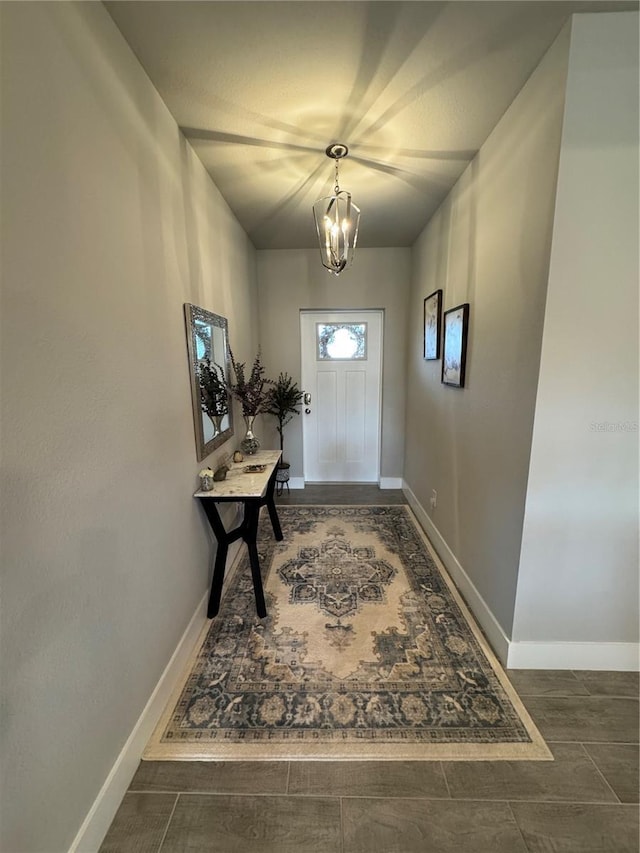 doorway to outside featuring a notable chandelier