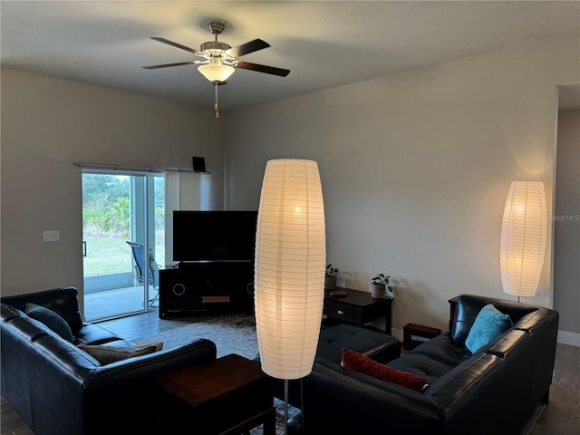 living room featuring wood-type flooring and ceiling fan