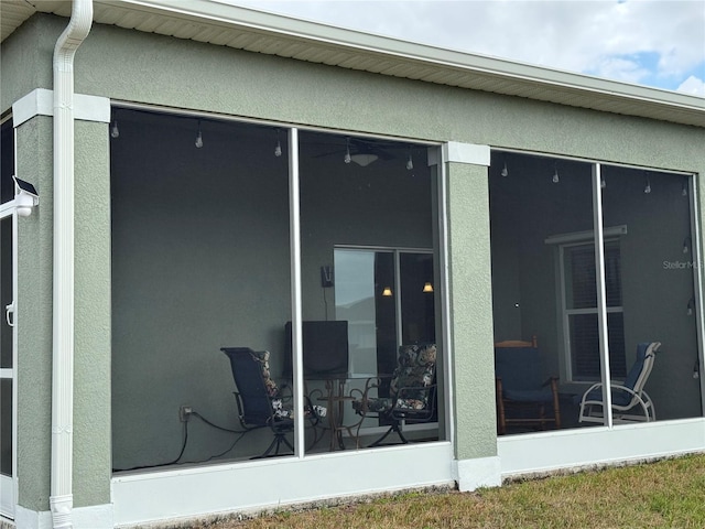 back of house featuring a sunroom