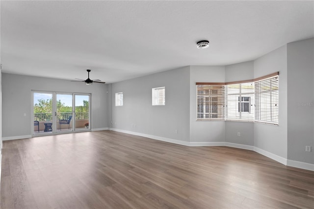 empty room featuring wood-type flooring and ceiling fan