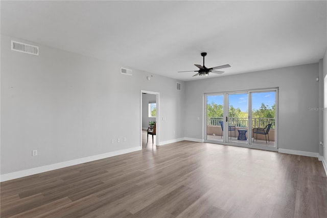 spare room with ceiling fan, hardwood / wood-style floors, and a wealth of natural light