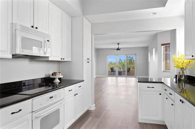 kitchen with white appliances, ceiling fan, white cabinets, kitchen peninsula, and light wood-type flooring