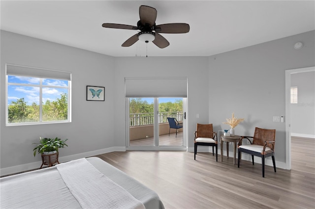 bedroom with light hardwood / wood-style flooring, access to outside, and ceiling fan