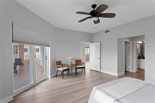 bedroom featuring access to exterior, light hardwood / wood-style floors, and ceiling fan