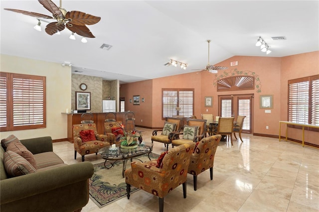 living room featuring vaulted ceiling, ceiling fan, and track lighting