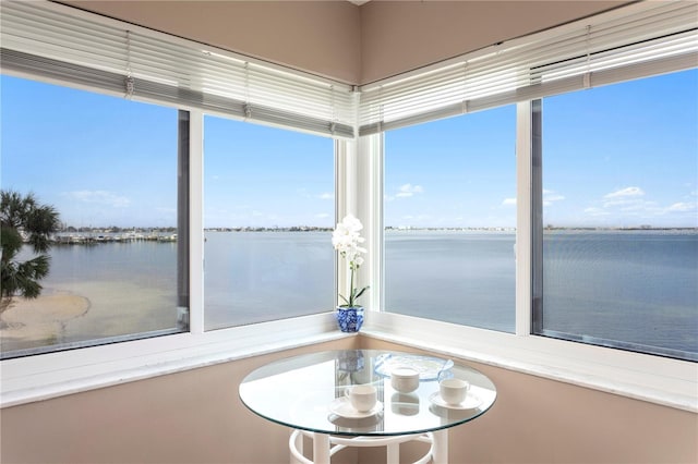 unfurnished sunroom with a water view and a wealth of natural light