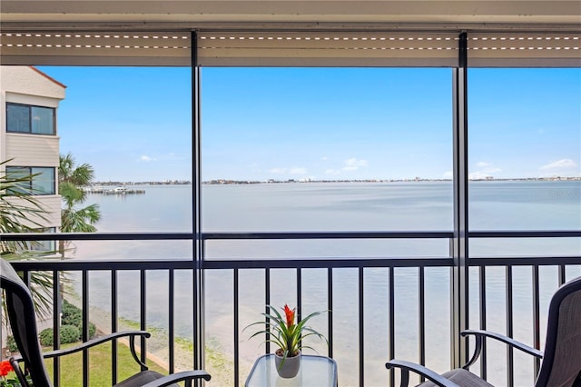 sunroom / solarium with a water view