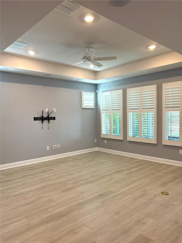 empty room with ceiling fan and light wood-type flooring