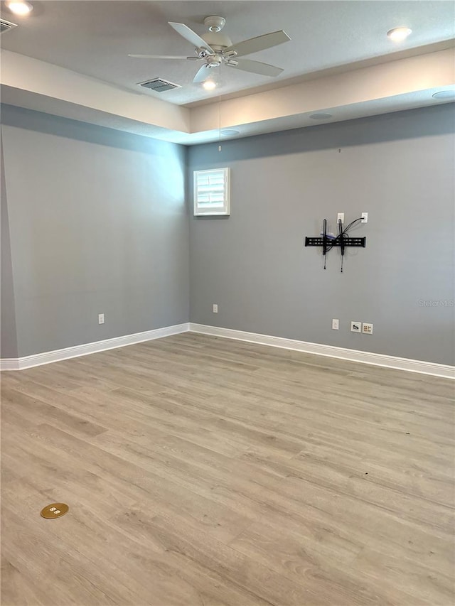 empty room featuring ceiling fan and light hardwood / wood-style flooring