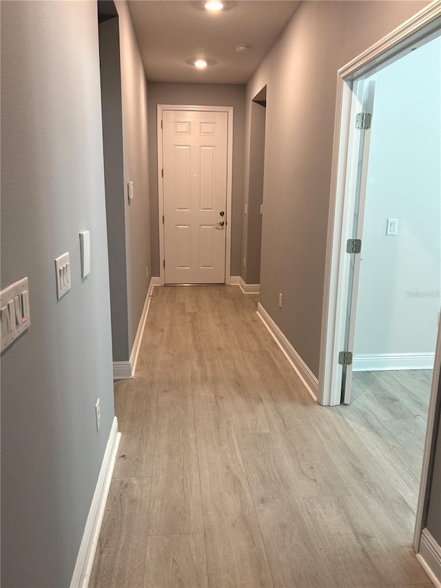 hall with light hardwood / wood-style flooring