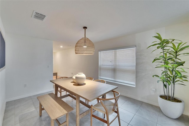 dining space featuring light tile patterned flooring