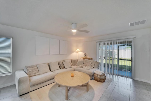 tiled living room with ceiling fan