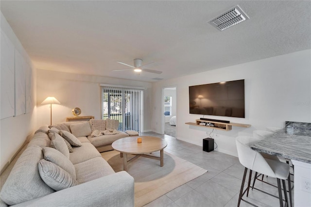 living room with light tile patterned floors and ceiling fan