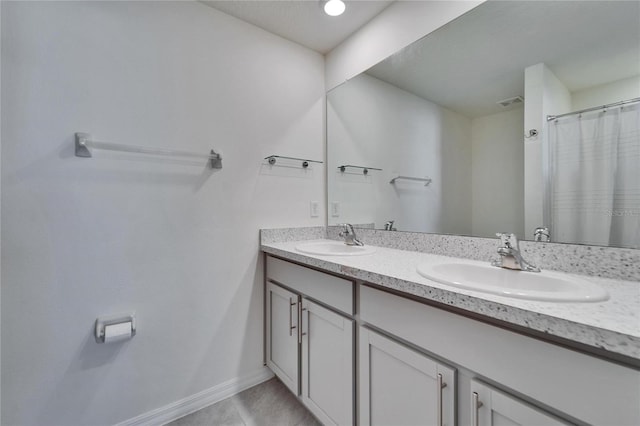 bathroom with tile patterned flooring and vanity