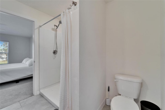 bathroom with tile patterned floors, toilet, and a shower with shower curtain