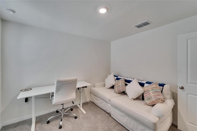 office area featuring a textured ceiling and carpet