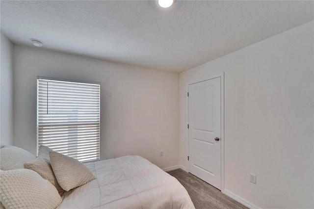 carpeted bedroom with a textured ceiling