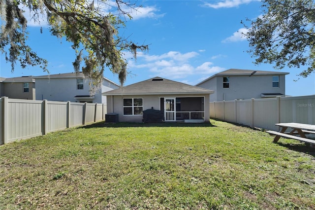 back of property featuring central AC, a sunroom, and a lawn