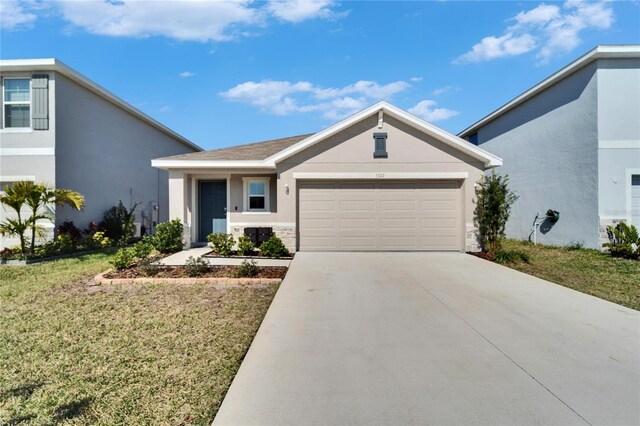 view of front of property with a garage and a front lawn