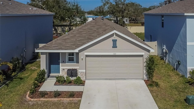 view of front of home with a garage and a front lawn