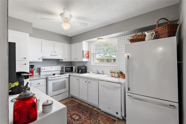 kitchen with white cabinetry, sink, white appliances, and ceiling fan