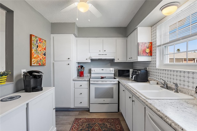 kitchen featuring white electric range, white cabinetry, sink, dark hardwood / wood-style flooring, and a textured ceiling